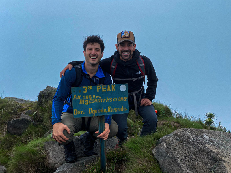 Two men mountain peak climb Uganda Follow Alice