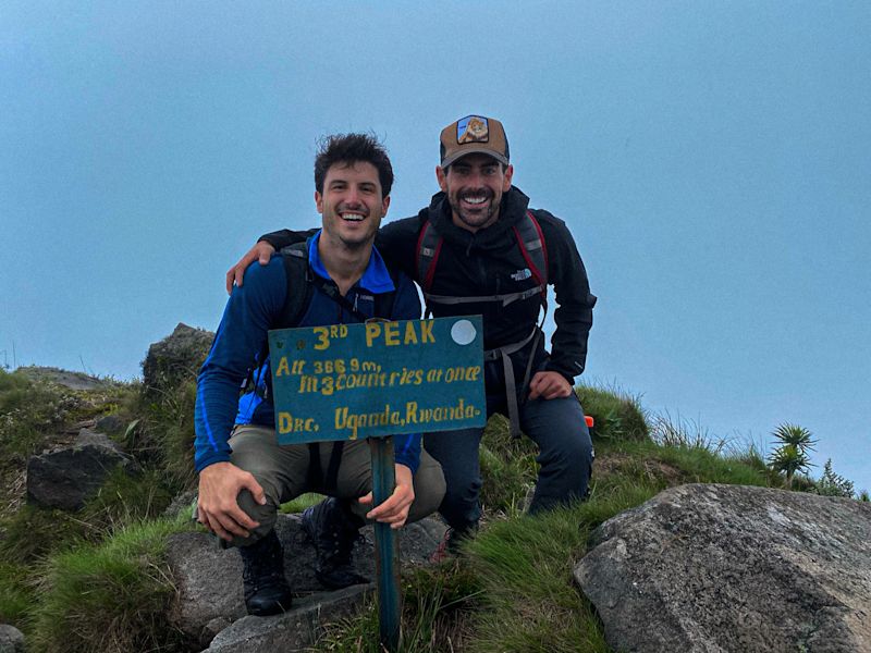 Two men mountain peak climb Uganda Follow Alice