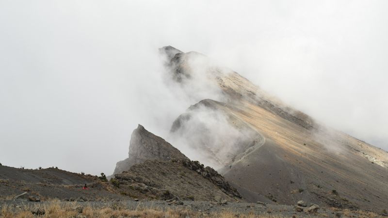 Side of Mt Meru crater draped in mist