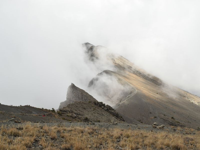 Side of Mt Meru crater draped in mist 