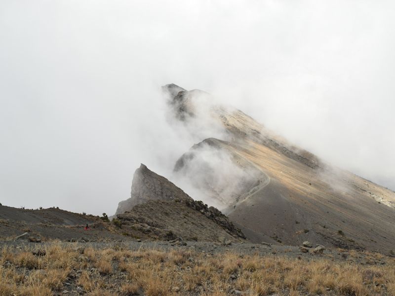 Side of Mt Meru crater draped in mist