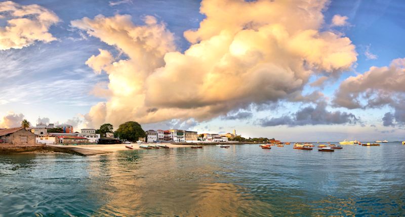 Panorama of Stone Town on Zanzibar island in Tanzania during sunrise with dramatic clouds.