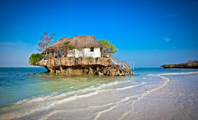 View from afar of Restaurant Rock among waves of Zanzibar, Tanzania