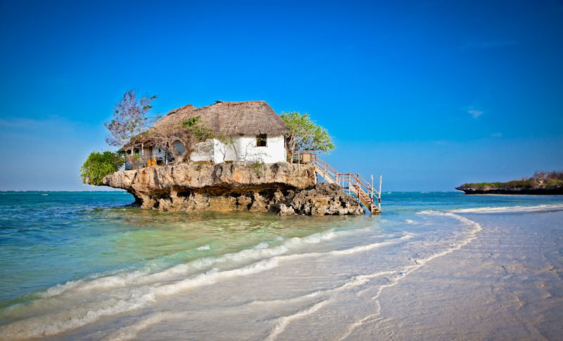 View from afar of Restaurant Rock among waves of Zanzibar, Tanzania