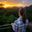 Refugio Amazonas - young woman facing sunset on canopy tower overlooking Tambopata in Peru's Amazon rainforest