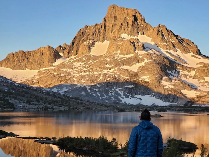 Trekker by lake on the John Muir Tail, USA