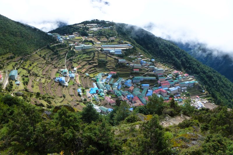 View from above of Namche Bazaar surrounded by green terraced fields, EBC trek, Nepal