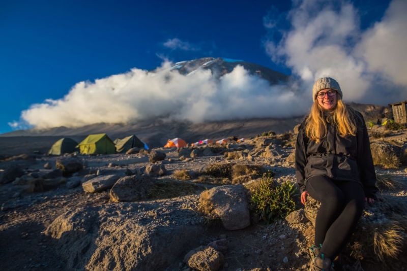 German-kilimanjaro-climber-at-the-base-camp-with-view-of-the-summit