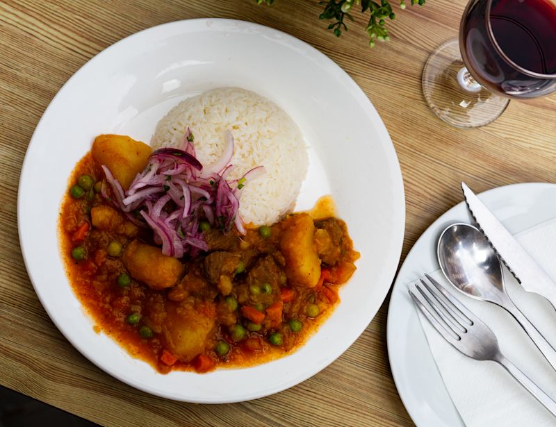 spicy veal with potatoes in gravy and rice - Peruvian dish