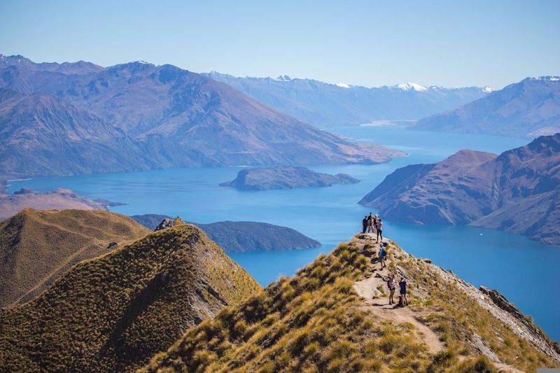 Group of hikers in mountains and by lake