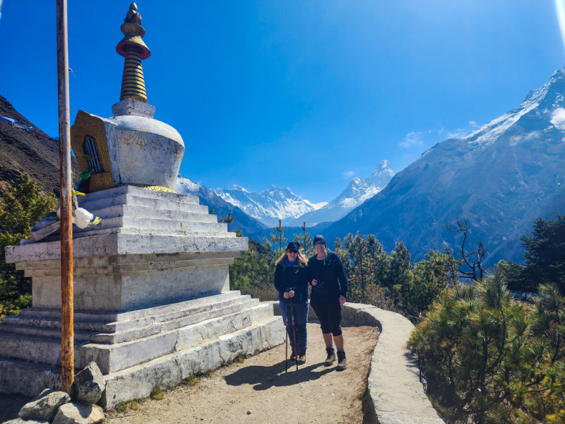 Couple standing by stupa with Ama Dablam behind them, EBc trek, Nepal 