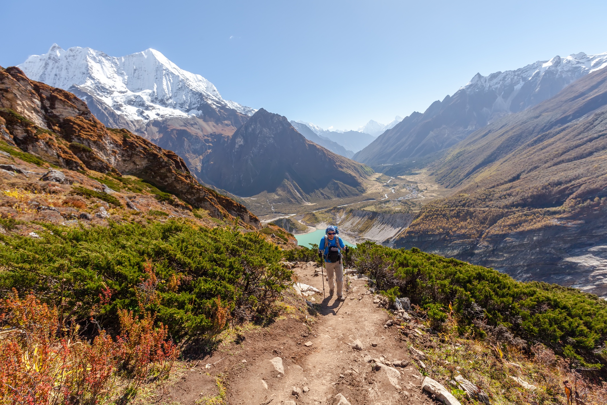 Hiker is climbing to Manaslu Base Camp in highlands of Himalayas on Manaslu Circuit, Nepal.