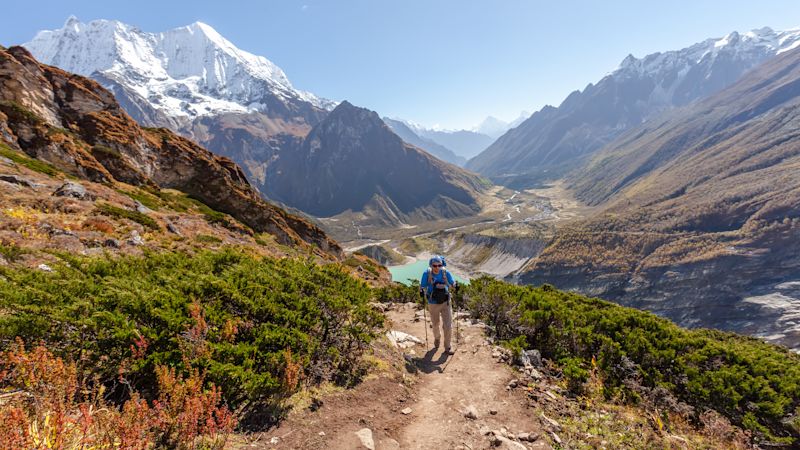 Hiker is climbing to Manaslu Base Camp in highlands of Himalayas on Manaslu Circuit, Nepal.