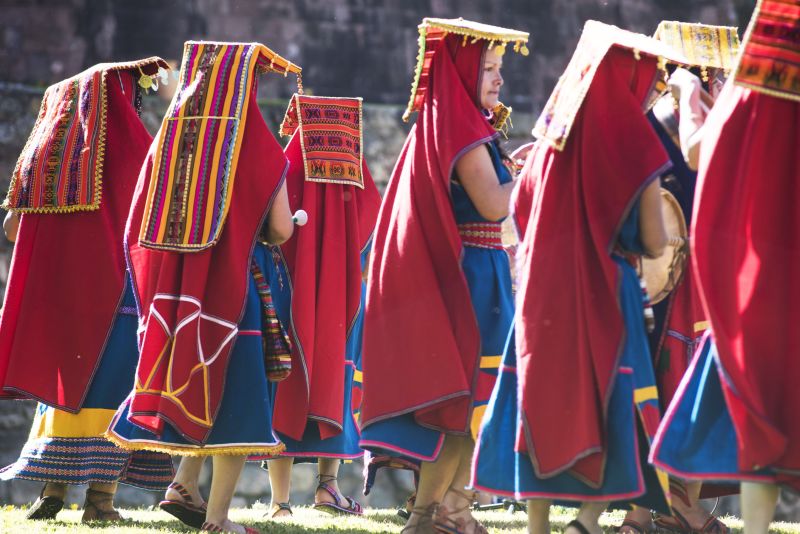 Women walking in traditional dress as part of an Inti Raymi festival at Saksaywaman on the outskirts of Cusco city