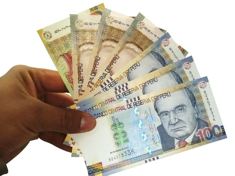 Peru nuevo soles money banknotes held in hand