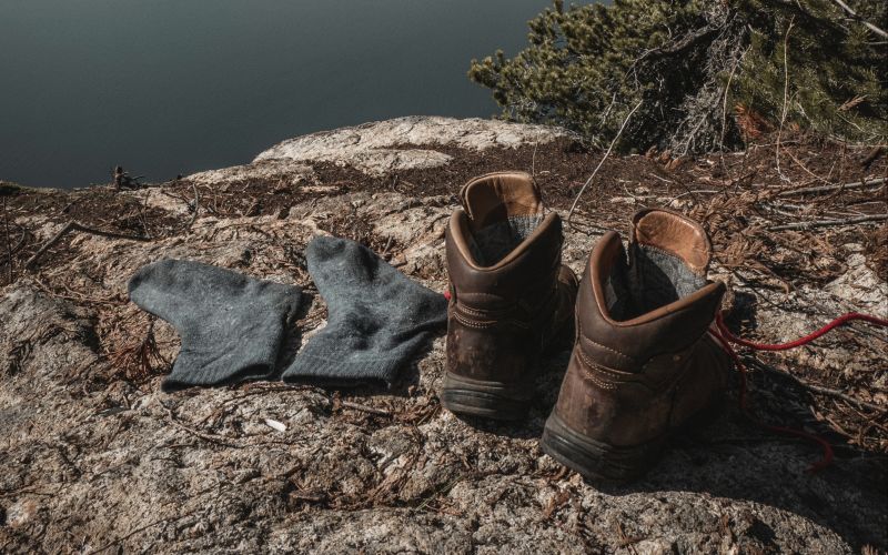 Hiking boots and socks on a rock
