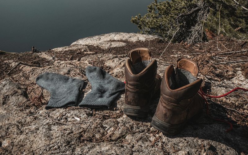 Hiking boots and socks on a rock