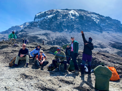 Group taking a rest stop on Kilimanjaro with Uhuru Peak behind
