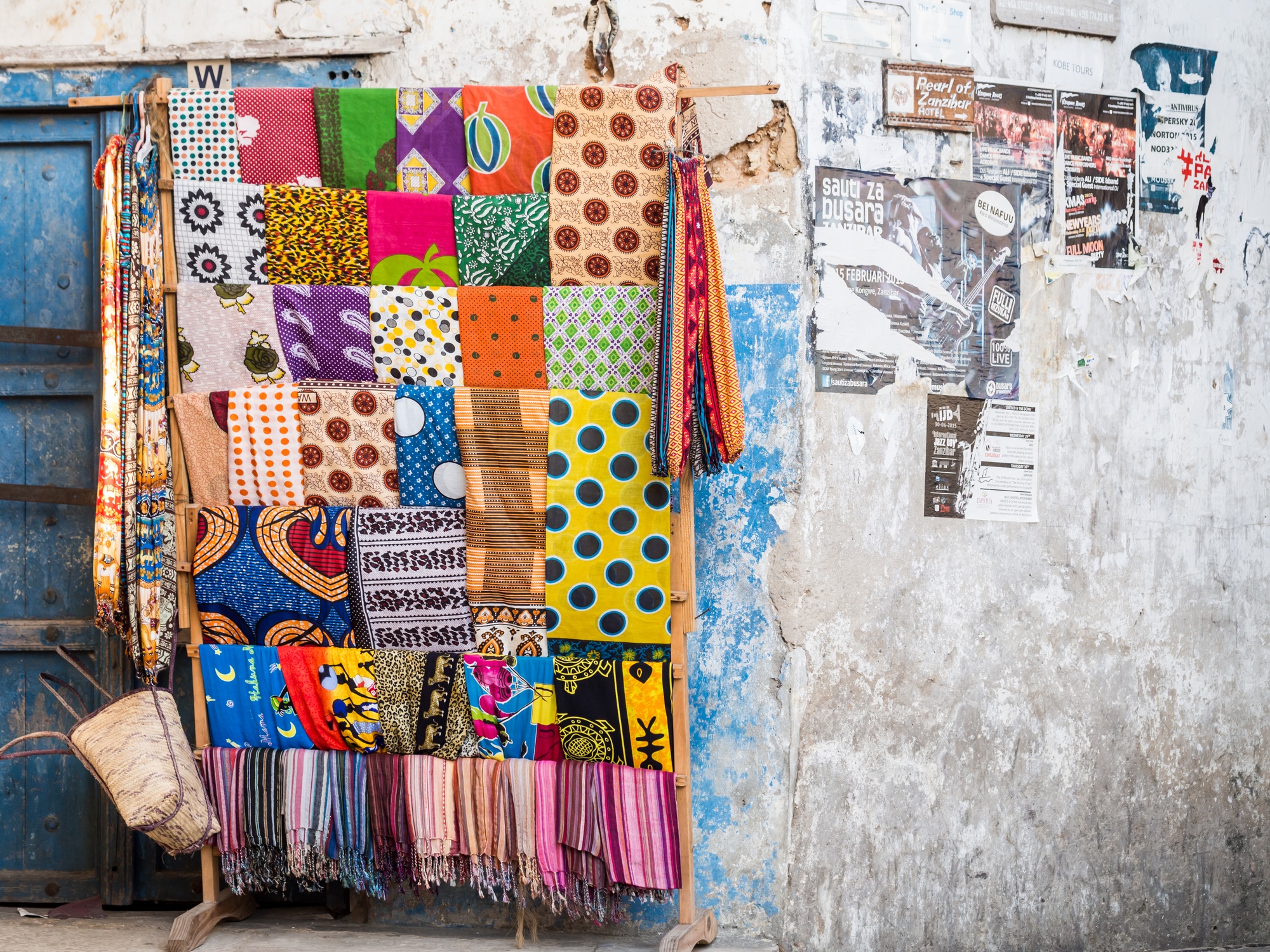 Colourful kangas and kitenges on sale in alley in Stone Town, Zanzibar