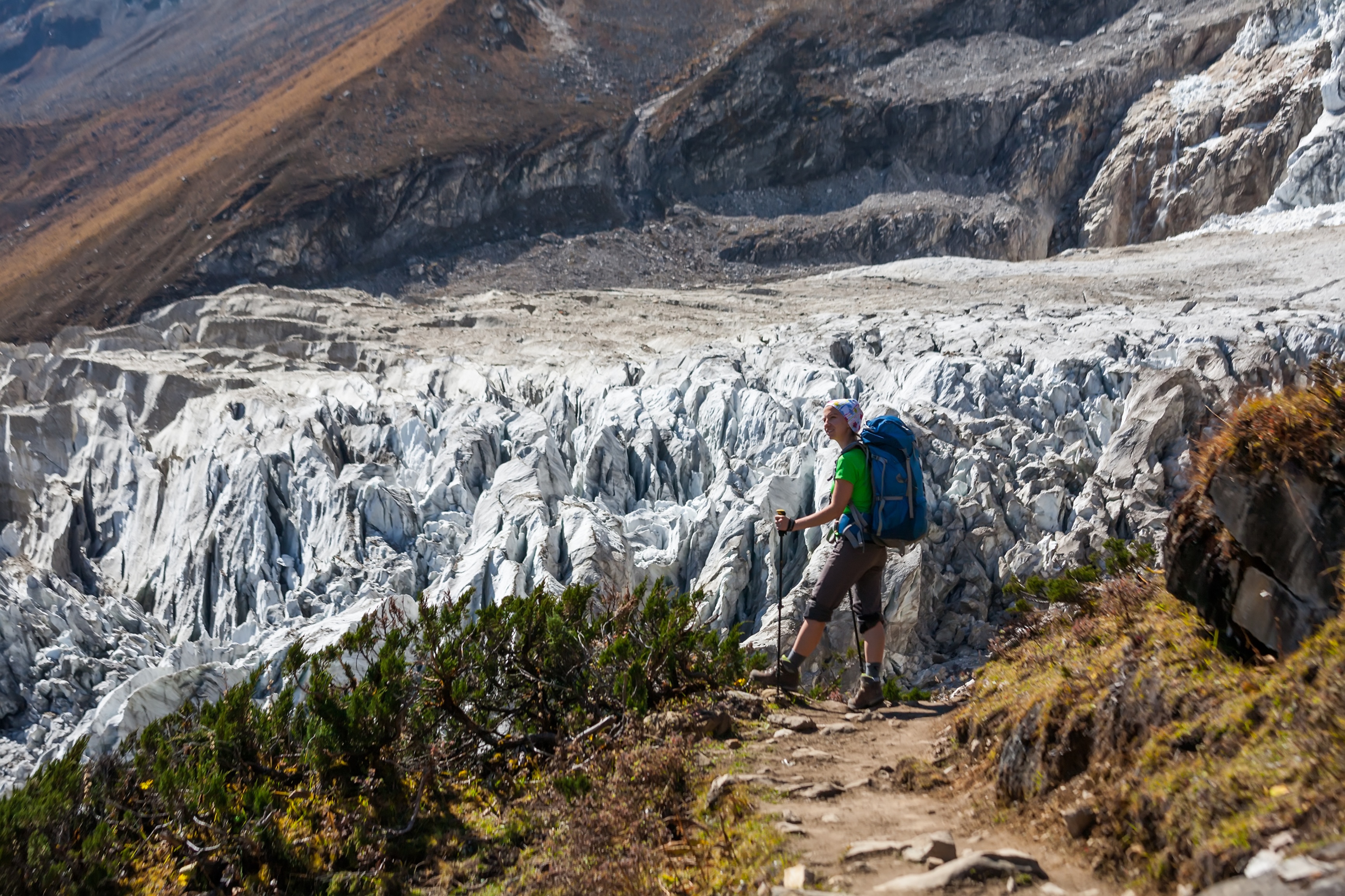 Trekker in front of Manaslu glacier on Manaslu circuit trek in Nepal.