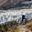 Trekker in front of Manaslu glacier on Manaslu circuit trek in Nepal.