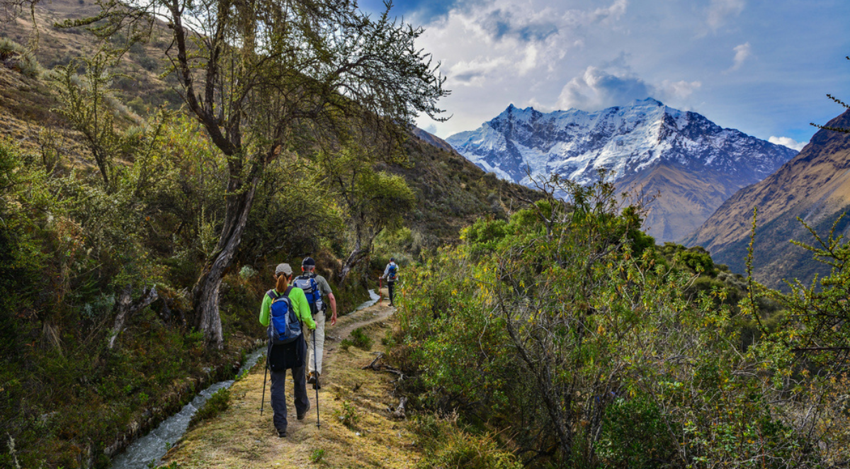 Trekkers with trekking poles and backpacks on Salkantay Trek en route to Machu Picchu