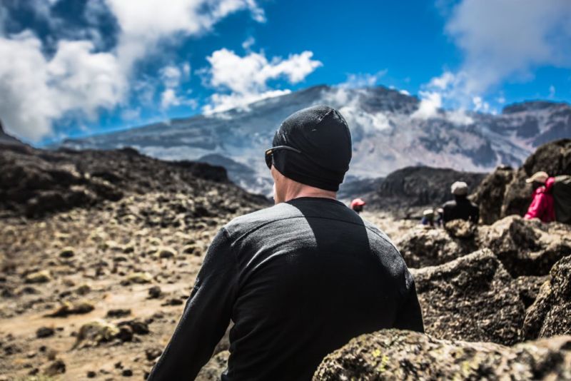 A man looking ahead at the peak of Kilimanjaro