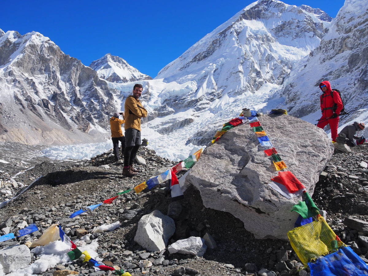 Everest Base Camp with flags and trekkers
