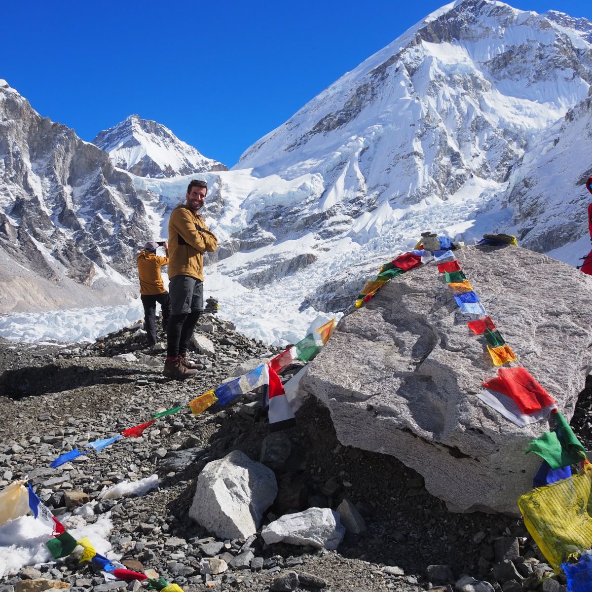 Everest Base Camp with flags and trekkers