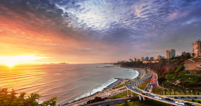 View of Lima coastline and sunset over Pacific Ocean and islands
