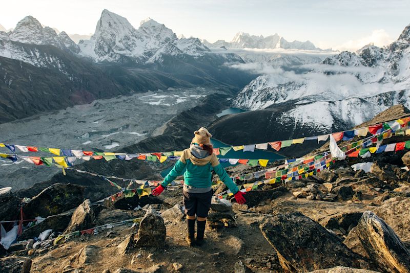 Woman trekker on Gokyo Ri looking at Gokyo Lakes, EBC trek