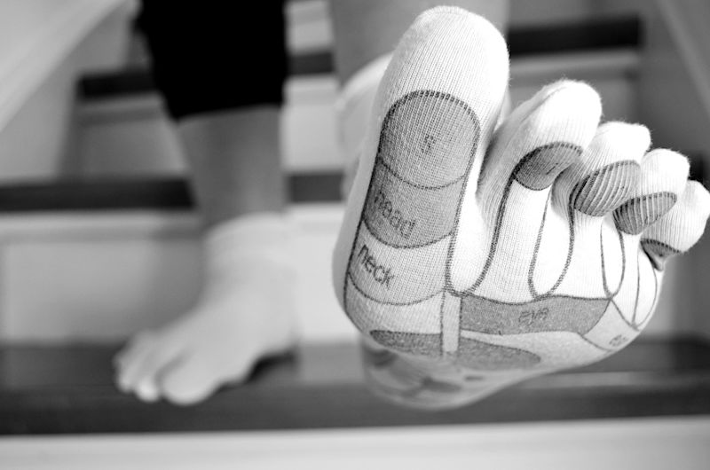 Close up of a foot in a toe sock on stairs