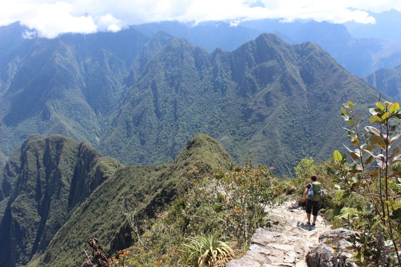 Man trekking in shorts and wearing a backpack on Inca Trail near Machu Picchu in Peru