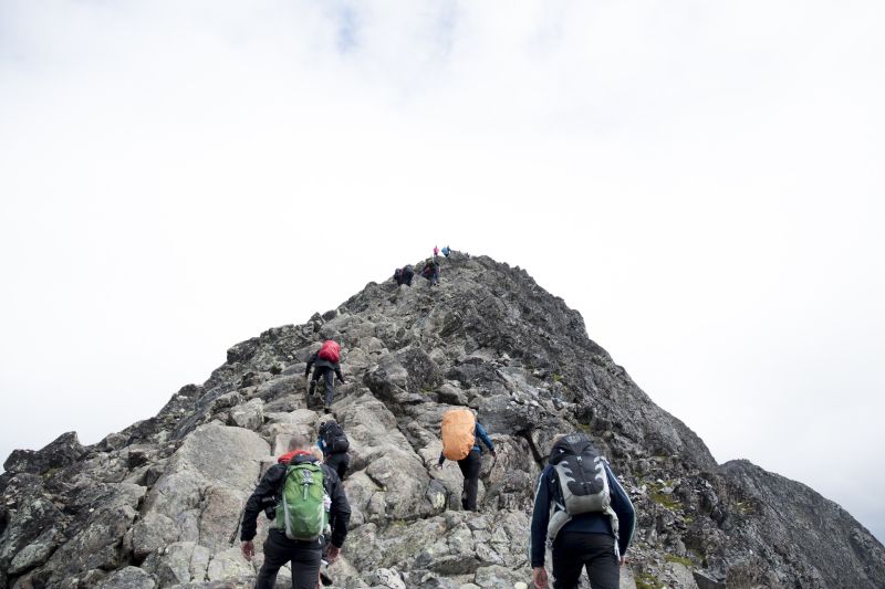 Hikers/trekkers climbing up a rocky peak
