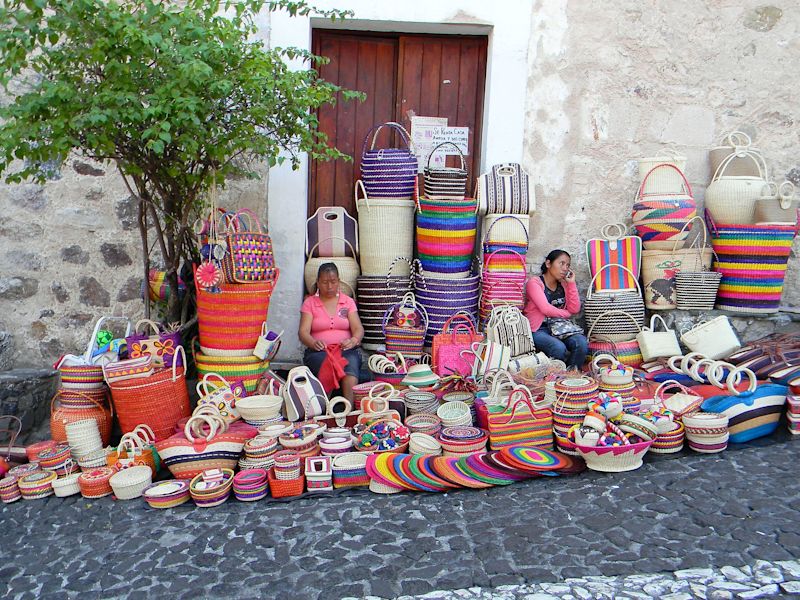 Street vendors South America woven baskets two women