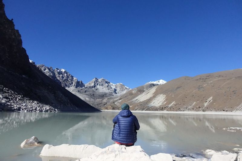 Man sitting by Gokyo Lake, Everest Base Camp packing list