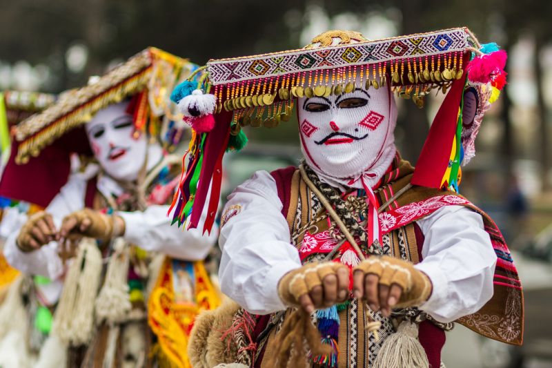 Qoyas dancers perform in masks and costumes during Corpus Christ week celebrations in Cusco, Peru