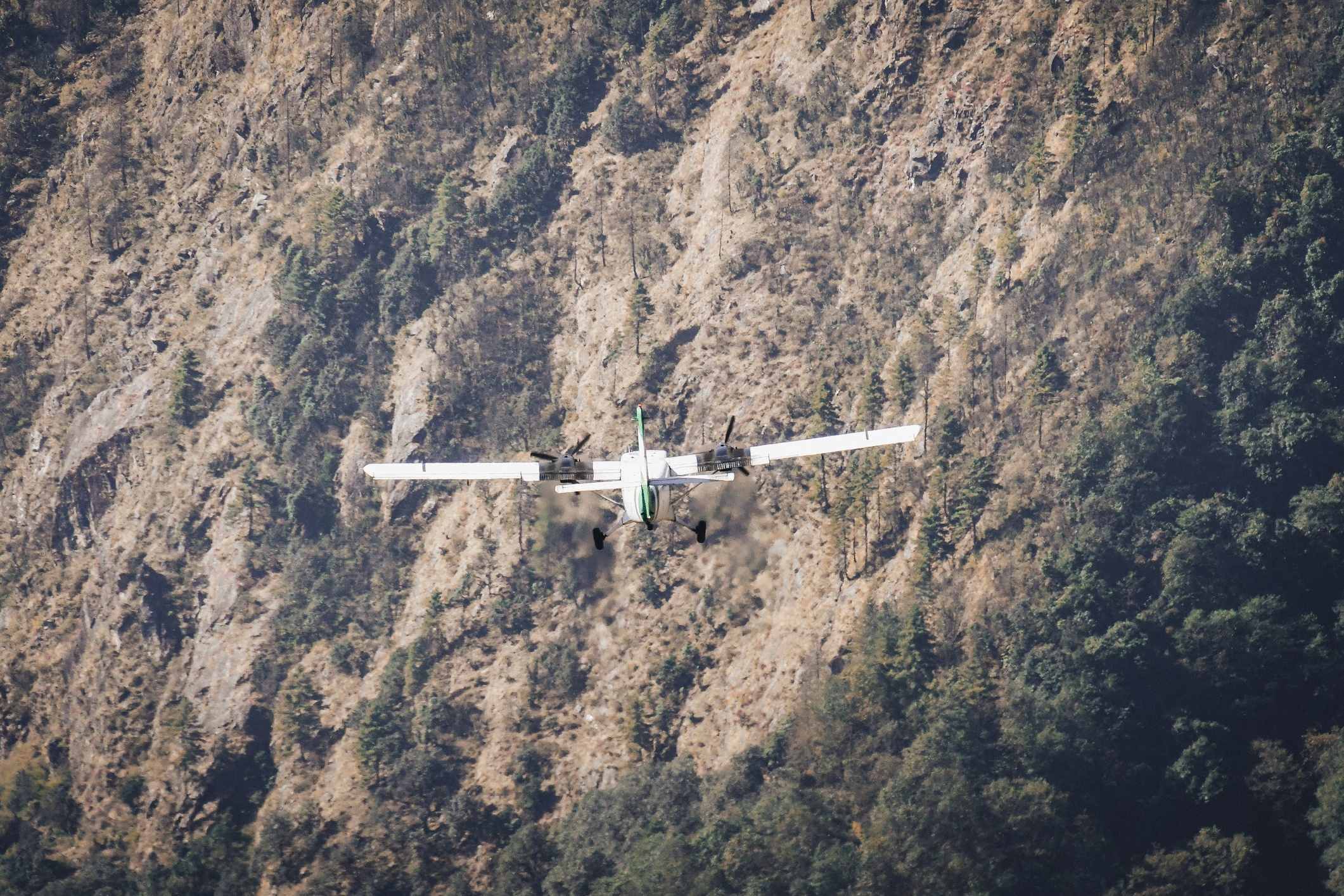 Small airplane in flight by Lukla Airport, Nepal