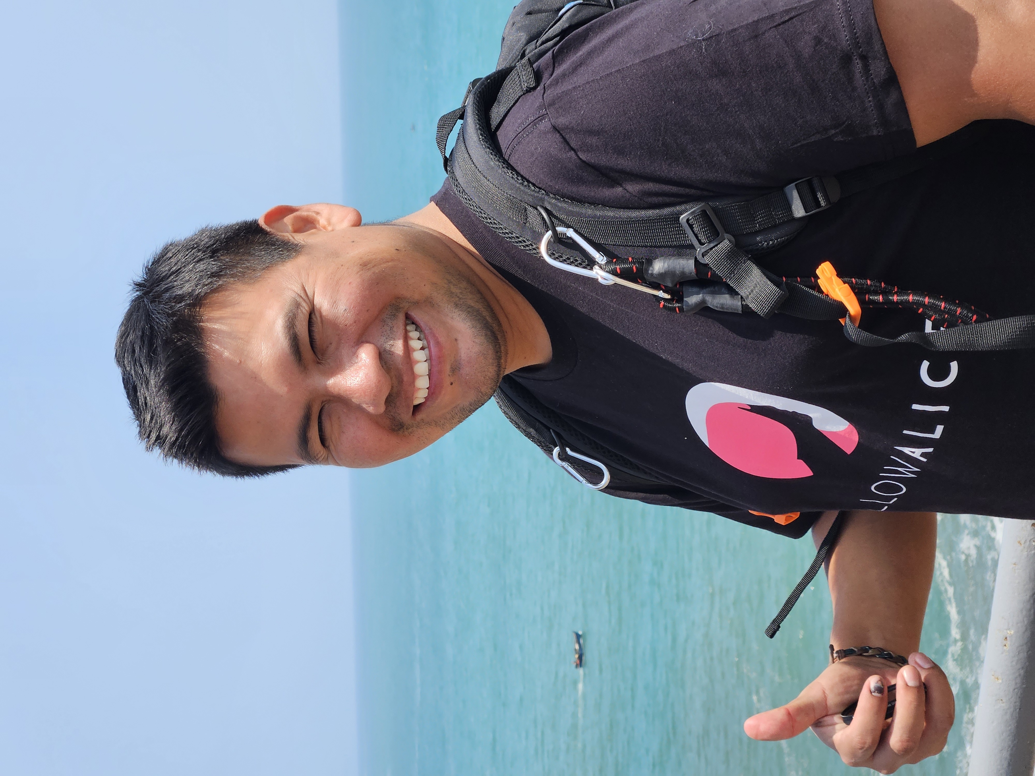 Peruvian man smiling with ocean behind him