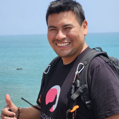 Peruvian man smiling with ocean behind him