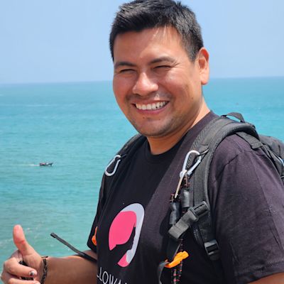 Peruvian man smiling with ocean behind him