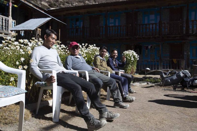 Men relaxing at a tea lodge on the Annapurna Circuit