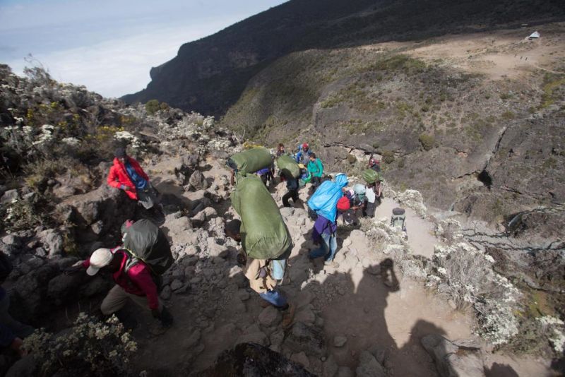 Follow Alice porters climbing up Kilimanjaro and carrying heavy loads