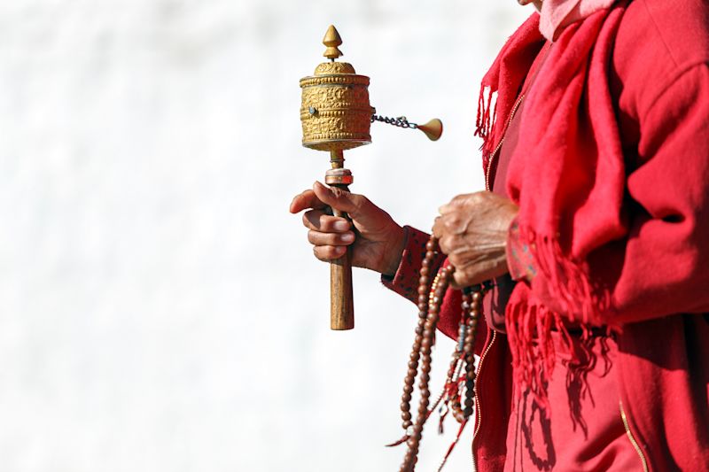 Tibetan prayer wheel in hand of old Bhutanese monk, Thimphu, Bhutan