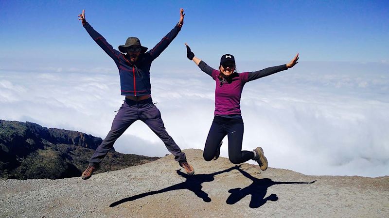 Couple jumping while climbing Kilimanjaro