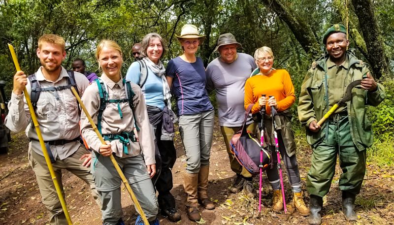 Mountain gorilla trekking group with ranger in Uganda