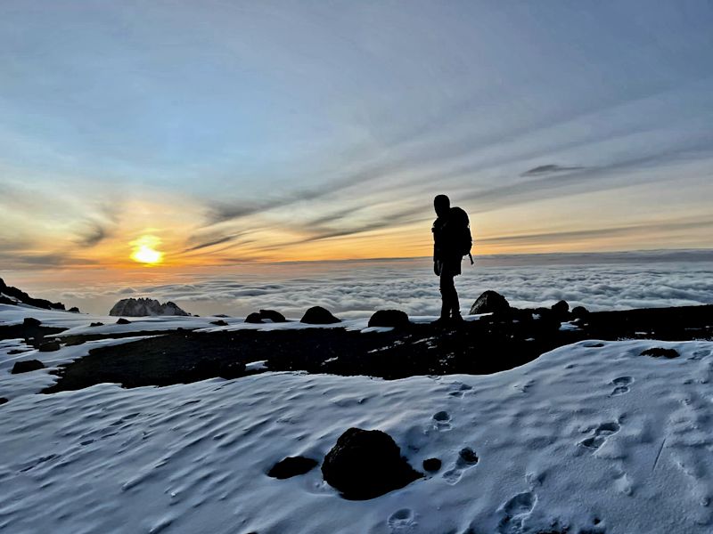 Kilimanjaro summit day snow clouds climber George K