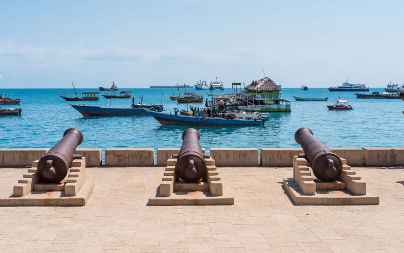 embankment with guns in Zanzibar Stone Town with boats in ocean