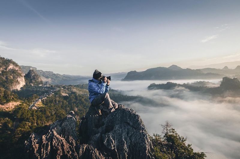 Man on trek taking photo