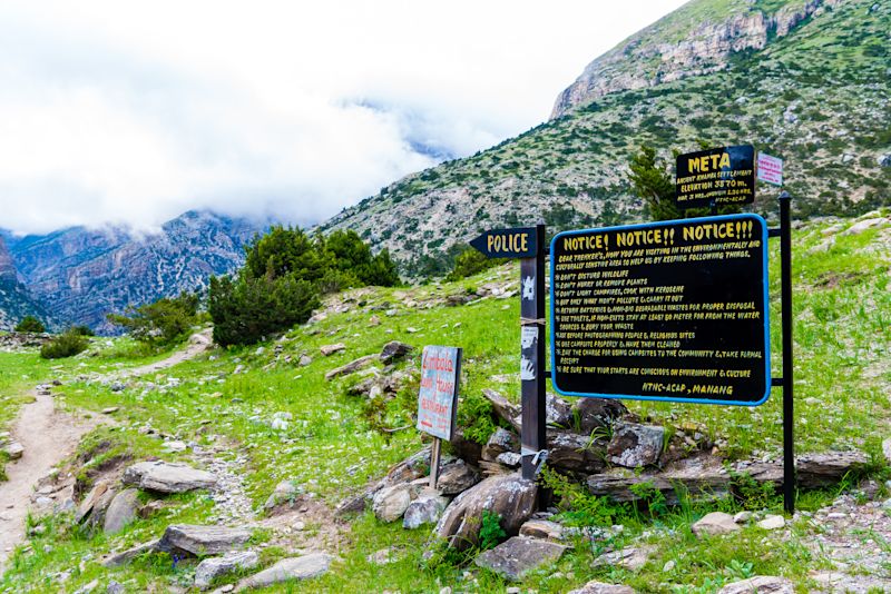 Welcome sign at the entrance to Meta village in Annapurna Conservation Area, Nepal